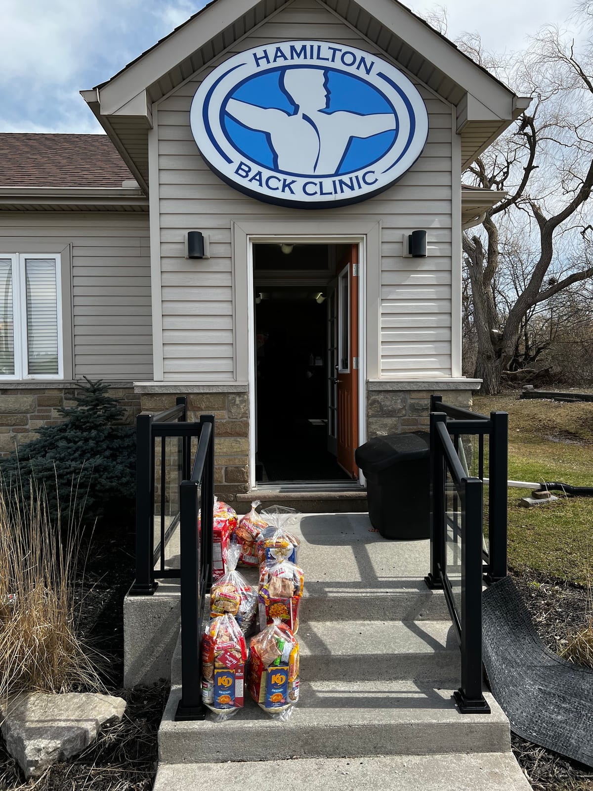 The Hamilton Back Clinic entrance under the clinic's blue sign
