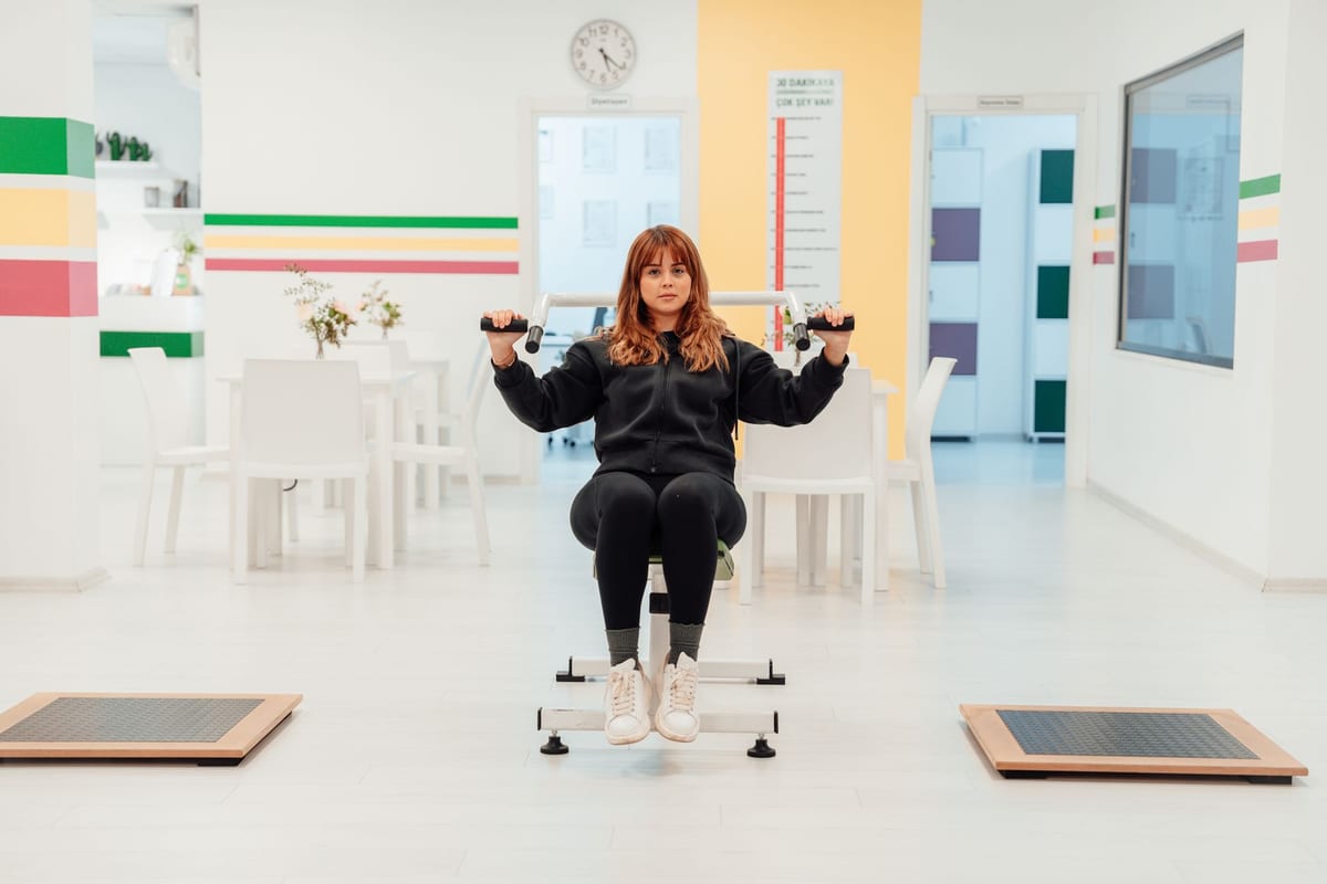 A patient working through a rehabilitation exercise in a bright room